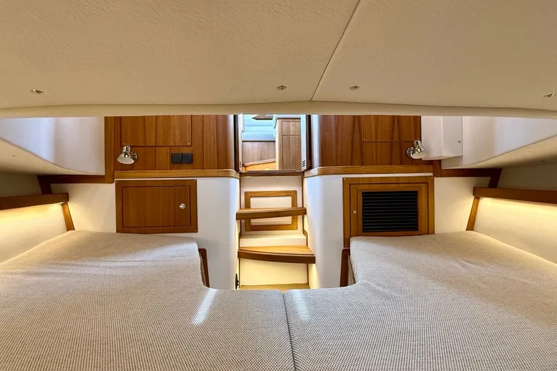 Slide: The Image of Interior of 2027 Targa 32 boat, featuring wooden cabinetry and cozy sleeping area. - 39