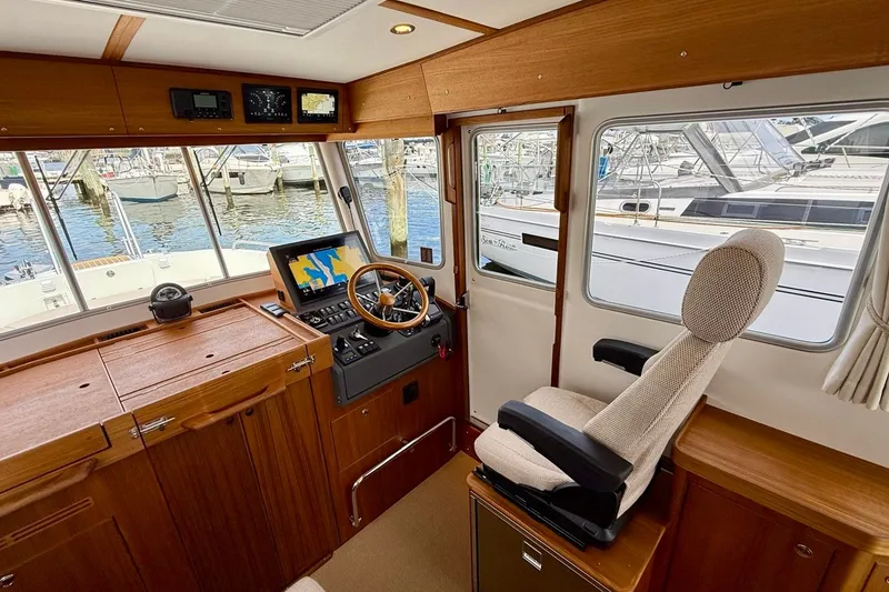 Slide: The Image of Interior of 2027 Targa 32 boat with helm, navigation equipment, and marina view. - 28