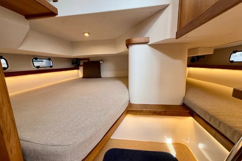 Slide: The Image of Luxurious interior cabin of 2027 Targa 32 boat with cozy bedding and ambient lighting. - 20