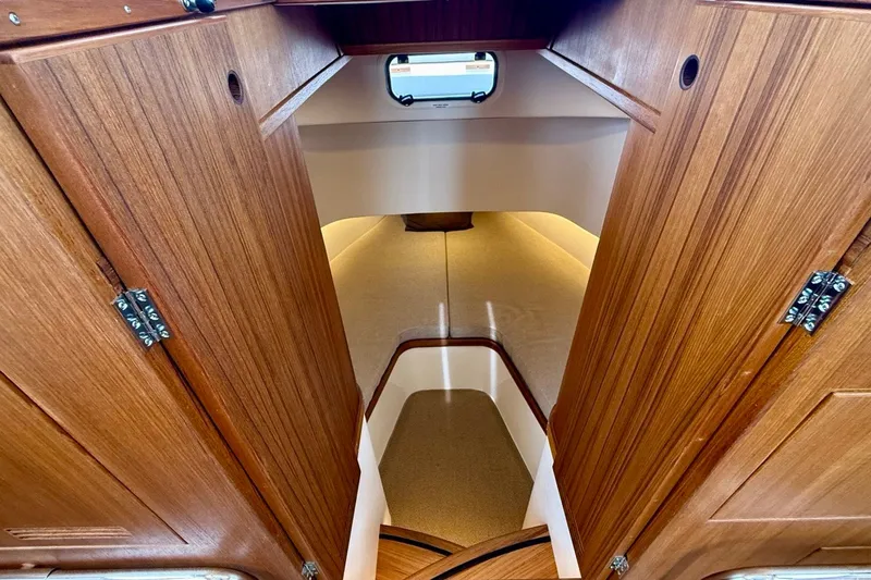 Slide: The Image of Interior view of 2027 Targa 32 boat cabin with wooden finish and cozy seating. - 36