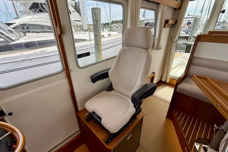 Slide: The Image of Captain's chair in 2027 Targa 32 boat interior, with marina view through windows. - 33