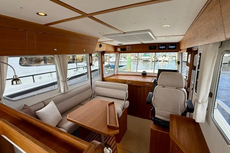 Slide: The Image of Luxurious interior of 2027 Targa 32 boat with wooden furnishings and comfortable seating. - 25