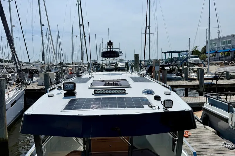 Slide: The Image of 2027 Targa 32 boat docked at marina, featuring solar panels and advanced navigation equipment. - 16