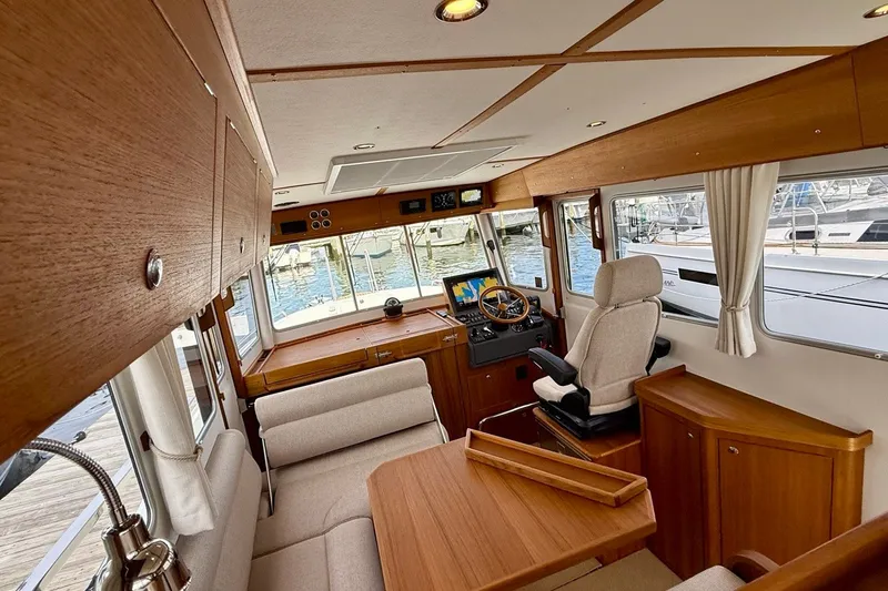 Slide: The Image of Luxurious interior of 2027 Targa 32 boat with wooden finishes and modern navigation equipment. - 26