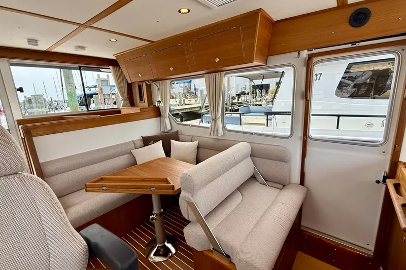 Slide: The Image of Interior of 2027 Targa 32 boat with cozy seating and wooden accents. - 31