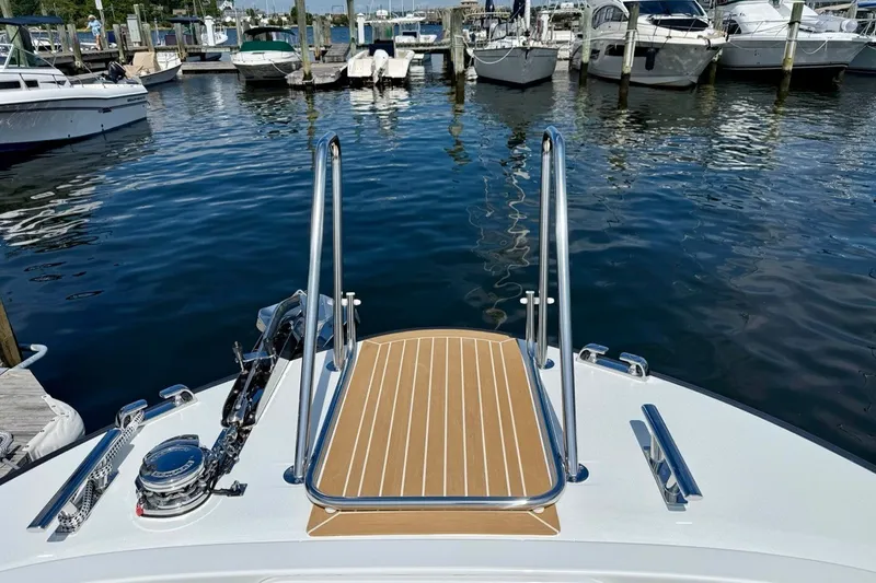 Slide: The Image of Bow view of 2027 Targa 32 yacht docked at marina with clear water. - 15