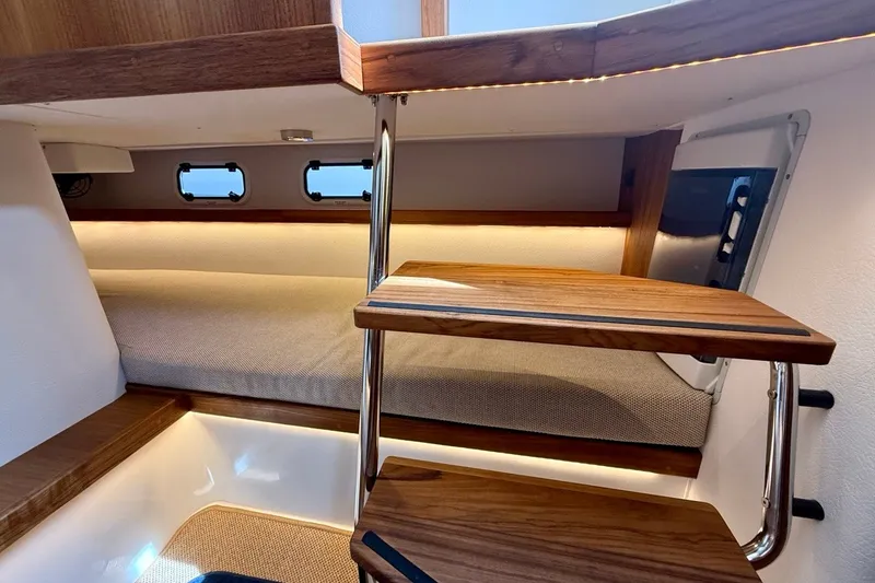 Slide: The Image of Modern interior of 2027 Targa 32 boat with wooden steps and cozy seating area. - 19