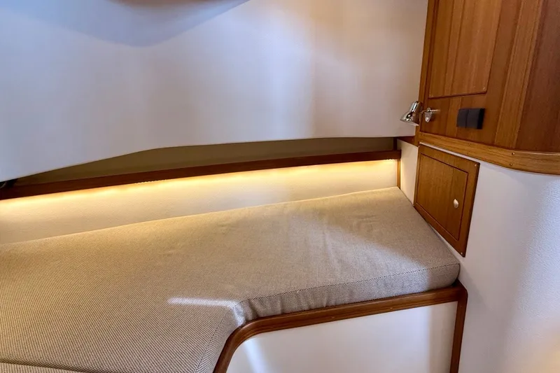 Slide: The Image of Cozy cabin interior of 2027 Targa 32 boat with wooden accents and ambient lighting. - 38