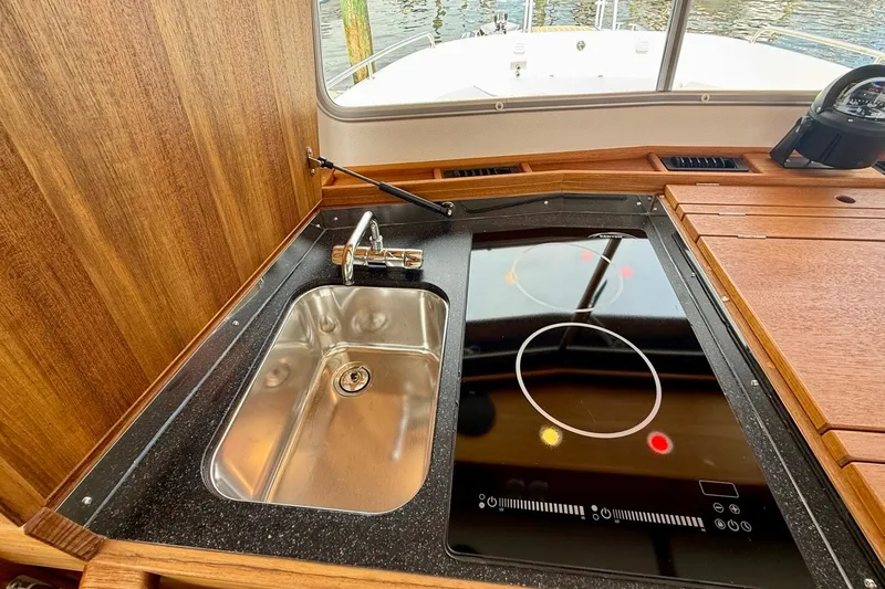 Slide: The Image of Modern kitchen area on 2027 Targa 32 boat with sink and induction cooktop. - 35