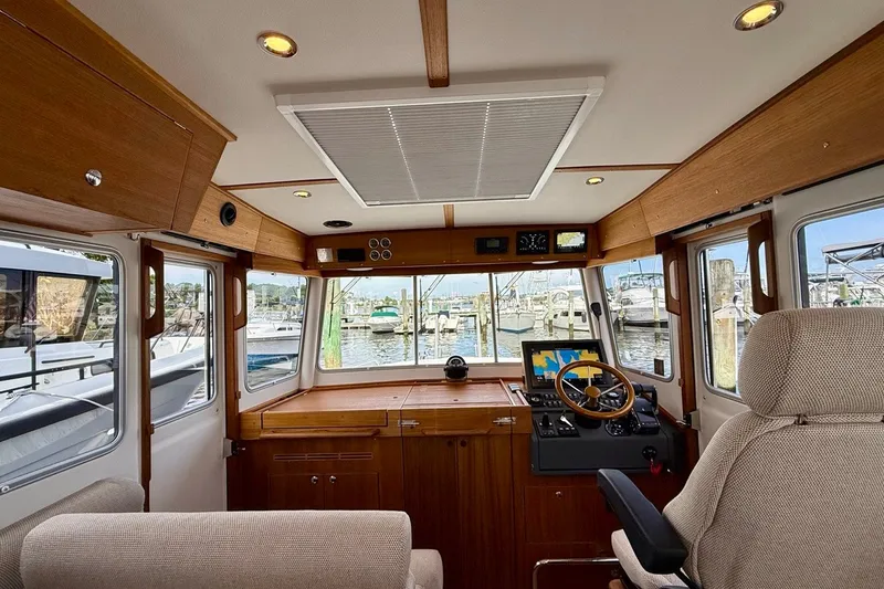 Slide: The Image of Interior of 2027 Targa 32 boat with wooden accents and modern navigation equipment. - 30