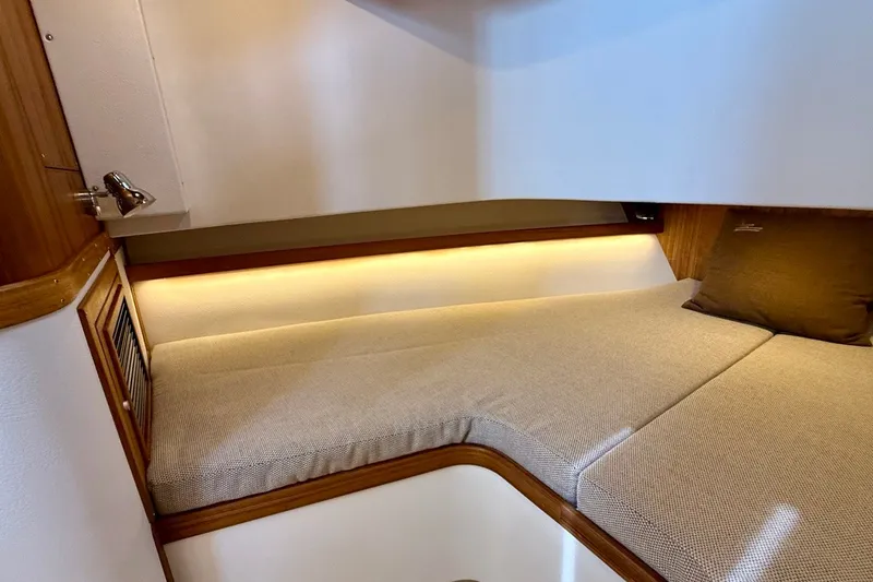 Slide: The Image of Cozy cabin interior of 2027 Targa 32 boat with ambient lighting and cushioned seating. - 37