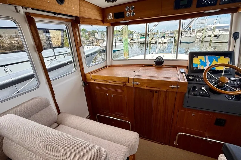 Slide: The Image of Interior of 2027 Targa 32 boat with wooden dashboard and navigation system. - 29