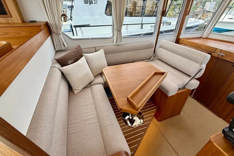 Slide: The Image of Luxurious interior of 2027 Targa 32 yacht with cozy seating and wooden table. - 27