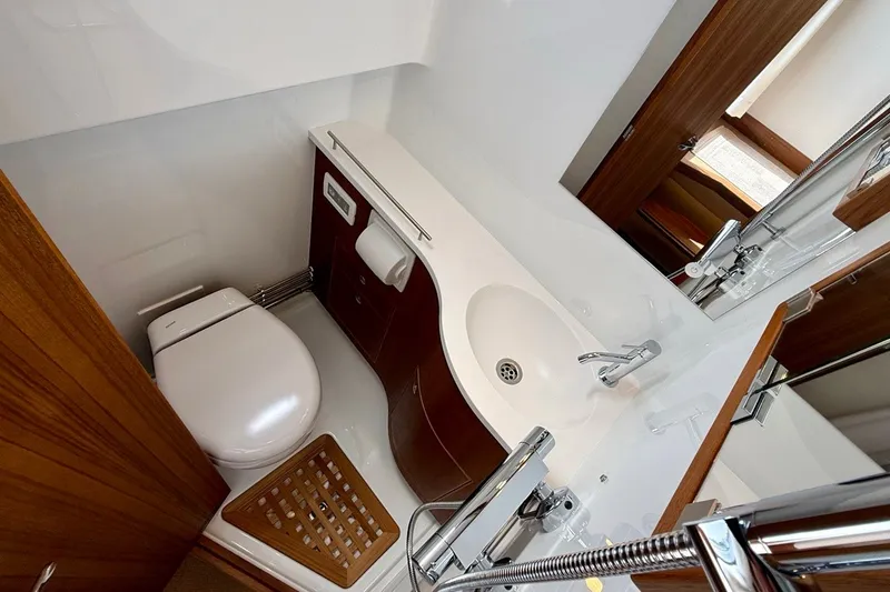 Slide: The Image of Modern bathroom interior on 2027 Targa 32 yacht, featuring sleek fixtures and wooden accents. - 24
