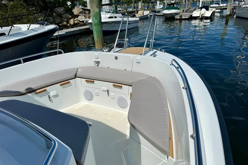 Slide: The Image of 2027 Targa 32 boat with cushioned seating, docked in a marina. - 14