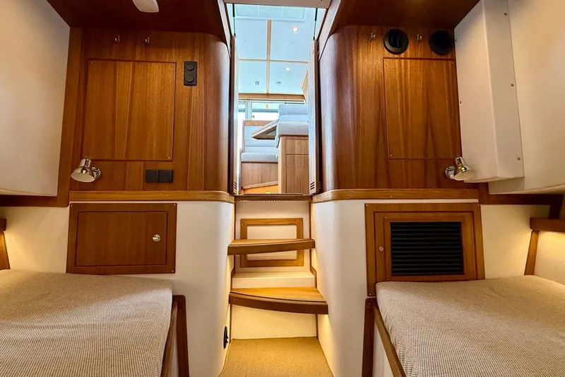 Slide: The Image of Interior of 2027 Targa 32 boat with wooden finishes and cozy seating area. - 40