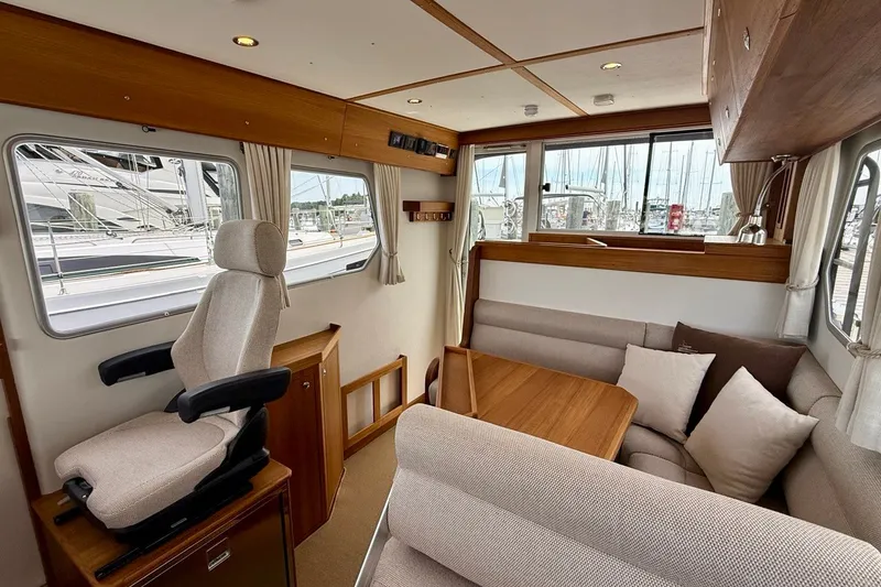 Slide: The Image of Interior of 2027 Targa 32 boat with seating and helm, featuring wood accents. - 32
