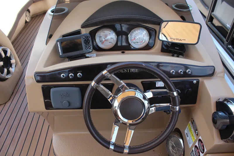 Slide: The Image of Steering console of 2018 Harris Solstice 240 boat with gauges and controls. - 12