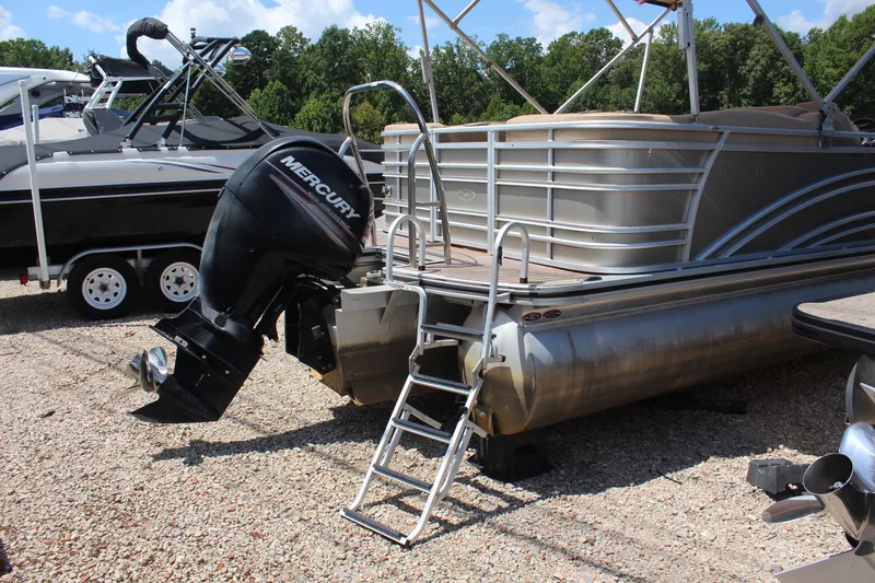 Slide: The Image of 2018 Harris Solstice 240 pontoon boat with Mercury outboard motor on gravel lot. - 5