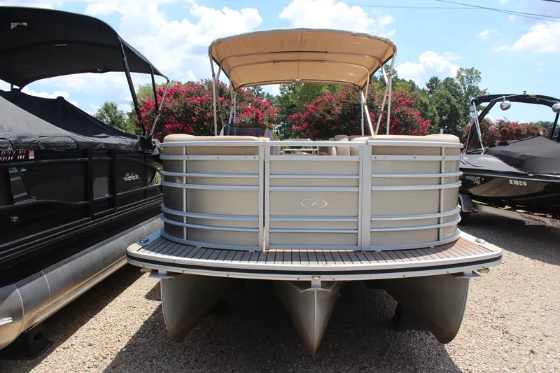 Slide: The Image of 2018 Harris Solstice 240 pontoon boat with canopy, parked outdoors. - 2