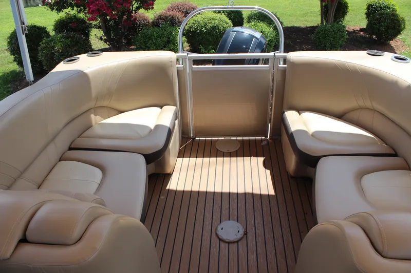 Slide: The Image of 2018 Harris Solstice 240 boat interior with beige seating and wooden flooring. - 9