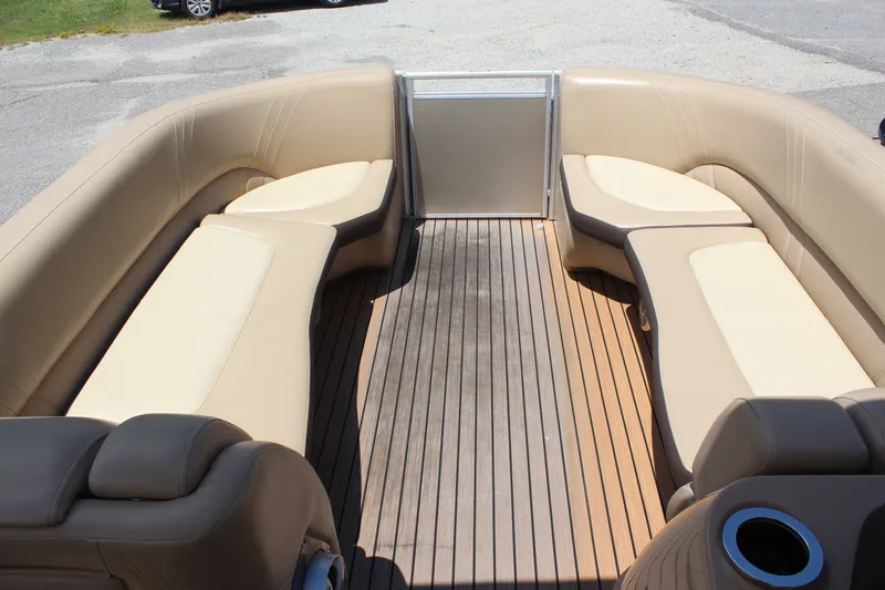 Slide: The Image of 2018 Harris Solstice 240 boat interior with beige seating and wooden flooring. - 7