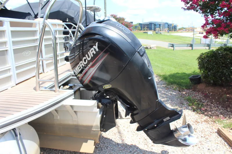 Slide: The Image of 2018 Harris Solstice 240 boat with Mercury outboard motor on a sunny day. - 4