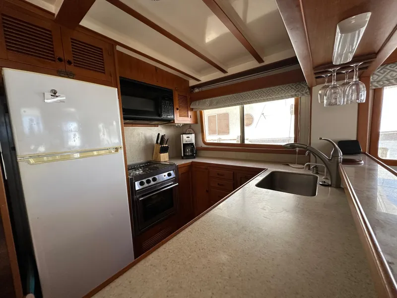 Slide: The Image of Kadey-Krogen 48 Whaleback 1997 yacht kitchen with modern appliances and wooden cabinetry. - 16