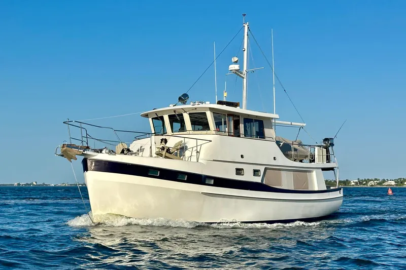 Slide: The Image of Kadey-Krogen 48 Whaleback 1997 yacht cruising on open water under clear blue sky. - 1
