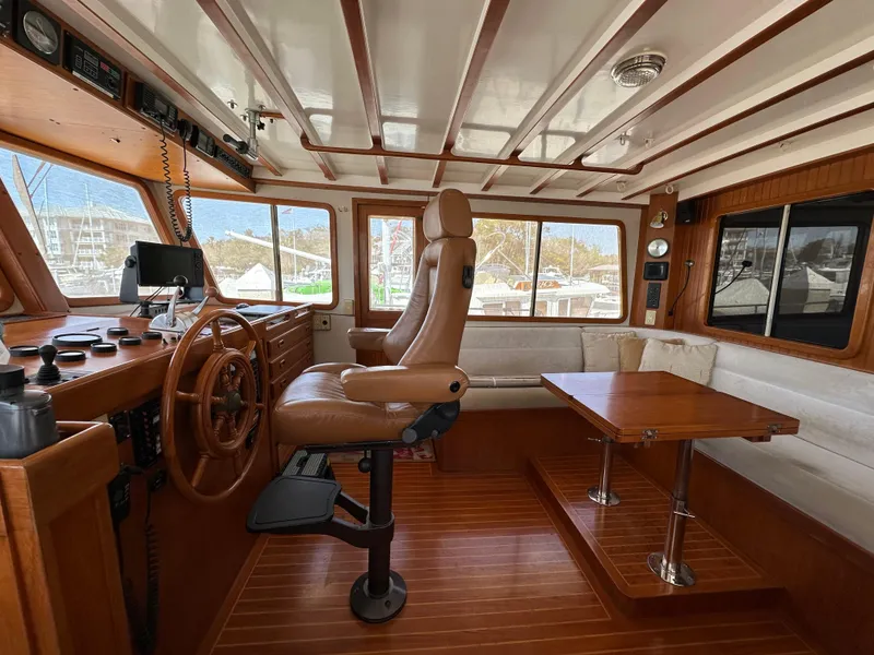 Slide: The Image of Interior of 1997 Kadey-Krogen 48 Whaleback yacht with helm, seating, and wooden accents. - 39