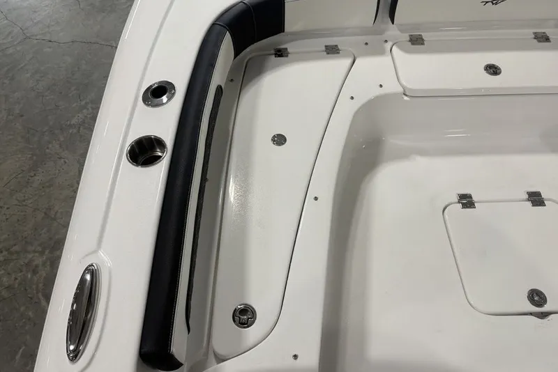 Slide: The Image of 2026 Tidewater 2300 Carolina Bay boat interior with storage compartments and cup holders. - 15