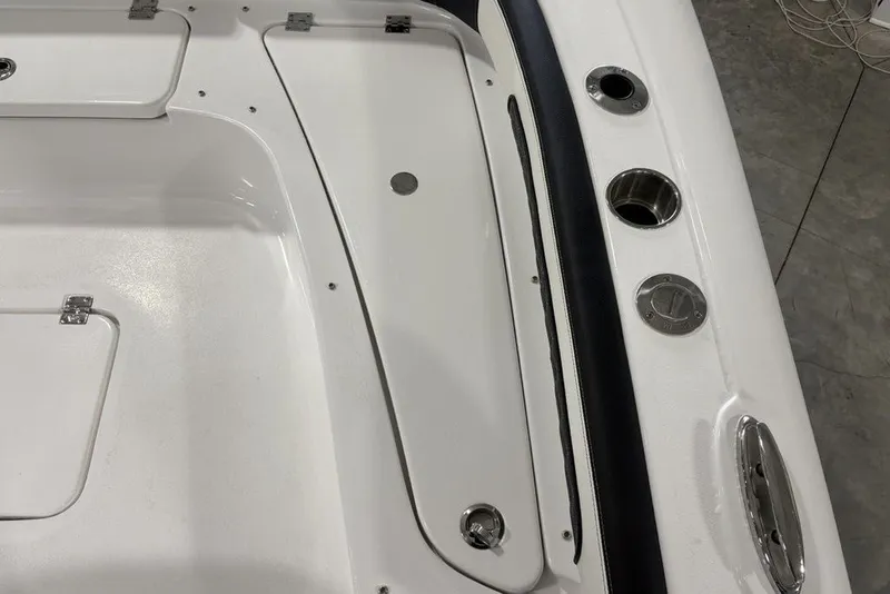Slide: The Image of 2026 Tidewater 2300 Carolina Bay boat interior with storage compartments and cup holders. - 24