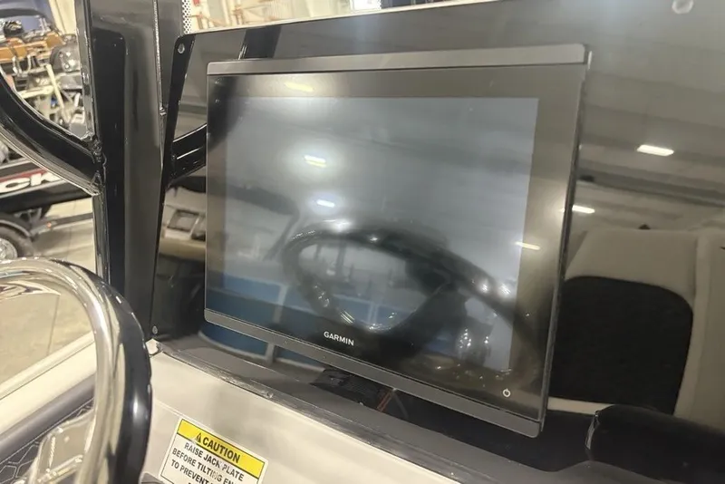 Slide: The Image of Garmin display on 2026 Tidewater 2300 Carolina Bay boat dashboard in showroom. - 19