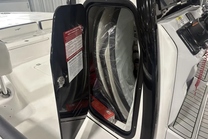 Slide: The Image of 2026 Tidewater 2300 Carolina Bay boat interior with open storage compartment. - 18