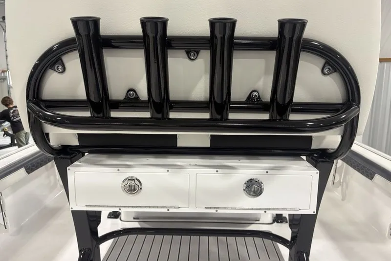 Slide: The Image of 2026 Tidewater 2300 Carolina Bay boat rod holders and storage compartment. - 28