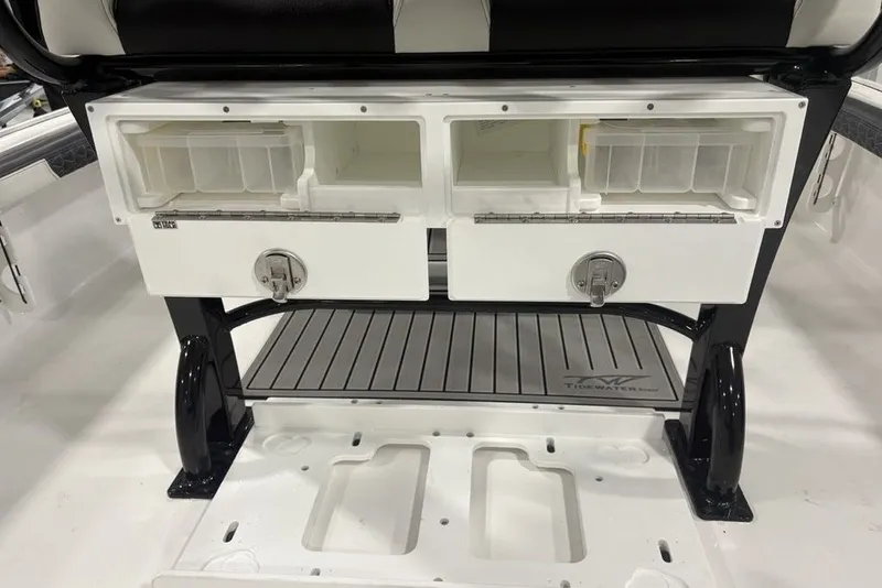 Slide: The Image of Tidewater 2300 Carolina Bay 2026 boat storage compartments with tackle boxes and secure latches. - 6