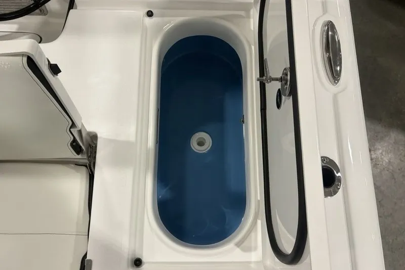 Slide: The Image of Livewell compartment in 2026 Tidewater 2300 Carolina Bay boat, featuring a blue interior. - 10