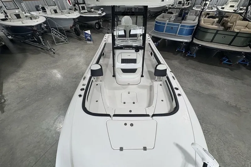 Slide: The Image of 2026 Tidewater 2300 Carolina Bay boat interior in showroom, showcasing seating and storage. - 12