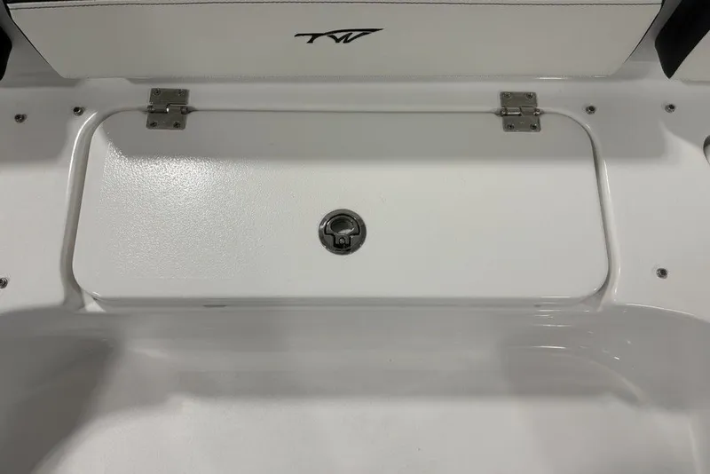 Slide: The Image of 2026 Tidewater 2300 Carolina Bay boat storage compartment with secure latch and sleek design. - 27