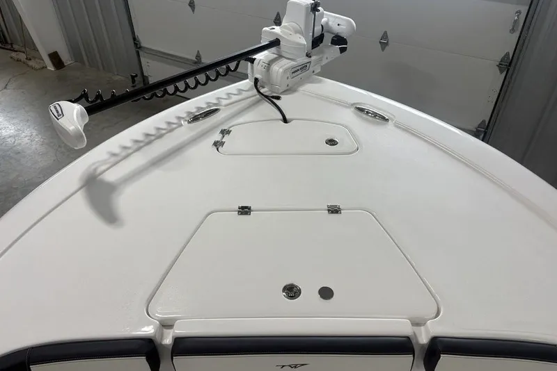Slide: The Image of 2026 Tidewater 2300 Carolina Bay boat deck with trolling motor in a garage setting. - 3