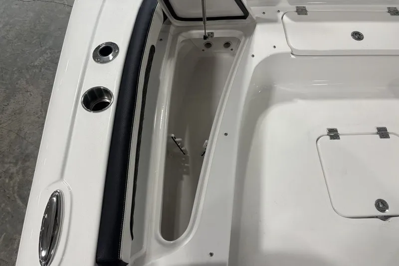 Slide: The Image of 2026 Tidewater 2300 Carolina Bay boat interior with storage compartments and cup holders. - 33