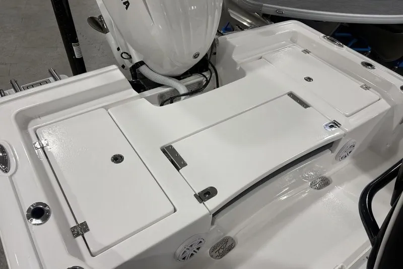 Slide: The Image of 2026 Tidewater 2300 Carolina Bay boat deck with storage compartments and motor. - 14