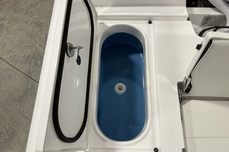 Slide: The Image of Livewell compartment in 2026 Tidewater 2300 Carolina Bay boat, featuring blue interior. - 11
