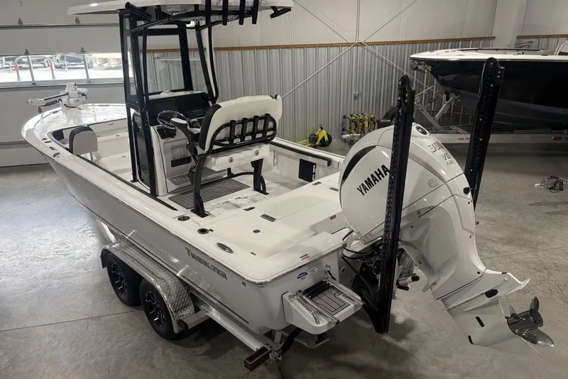 Slide: The Image of 2026 Tidewater 2300 Carolina Bay boat with Yamaha engine in a showroom. - 4