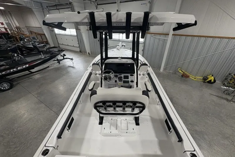 Slide: The Image of 2026 Tidewater 2300 Carolina Bay boat interior in a showroom, showcasing seating and console. - 9