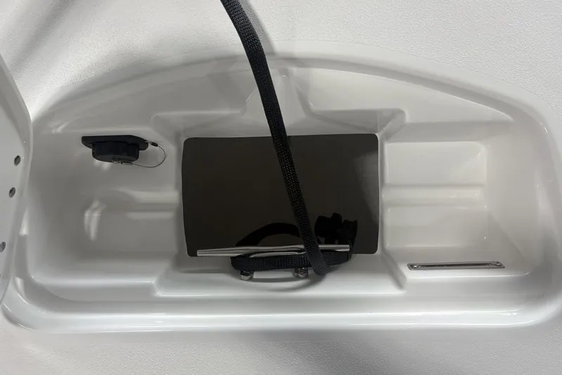 Slide: The Image of 2026 Tidewater 2300 Carolina Bay boat compartment with strap and plug socket. - 31