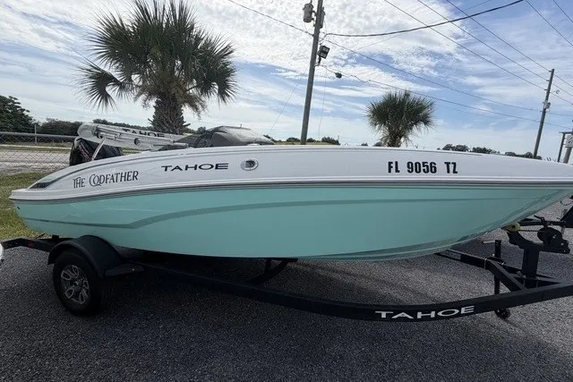 Slide: The Image of 2025 Tahoe T18 boat on trailer, parked outdoors with palm trees in background. - 4