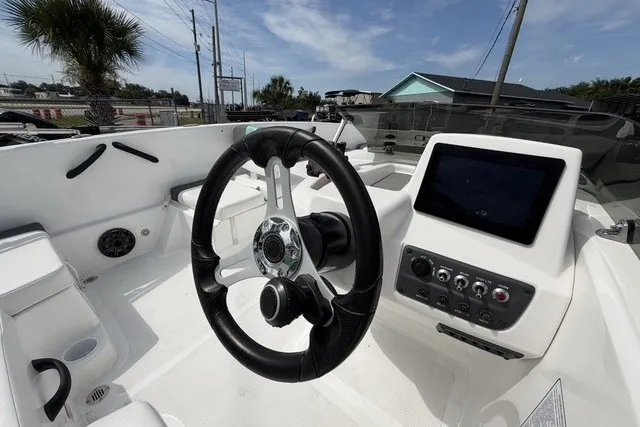 Slide: The Image of 2025 Tahoe T18 boat cockpit with steering wheel and control panel. - 12