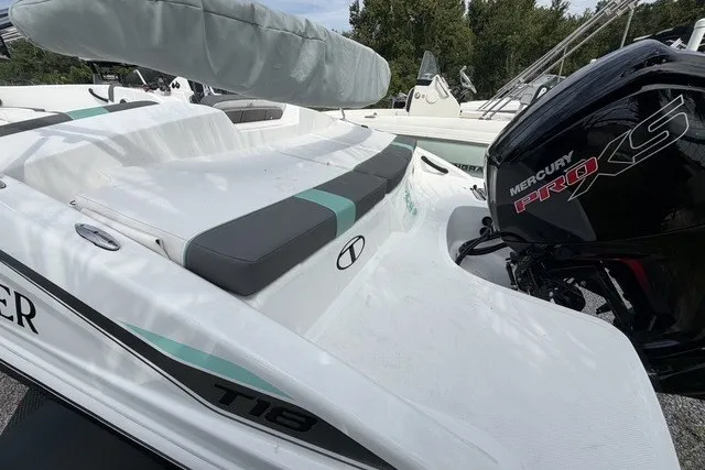 Slide: The Image of 2025 Tahoe T18 boat with Mercury Pro XS engine, featuring sleek white design and cushioned seating. - 7