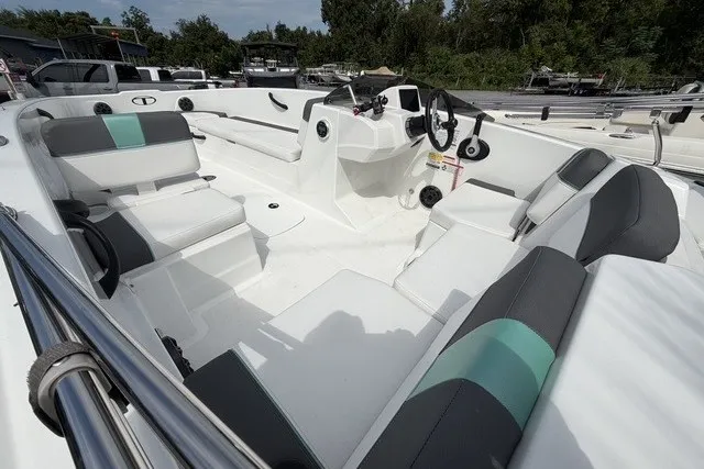 Slide: The Image of 2025 Tahoe T18 boat interior with modern seating and steering, docked outdoors. - 8